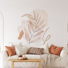 a living room with a couch, coffee table and wall mural