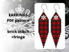 a pair of red and black plaid earrings with snowflakes in the back ground