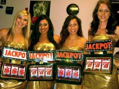 four women in gold dresses holding up slot machines with jackpot numbers on each side