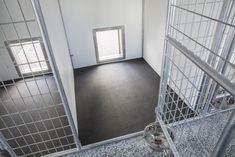 the inside of a jail cell with doors open