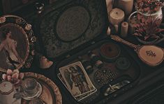 an assortment of antique items including candles, pictures and other decorative objects sit on the floor