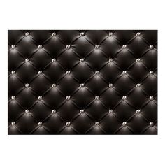 a black leather upholstered wall with diamond studding