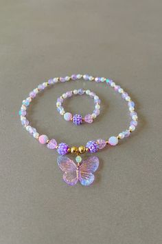 Butterfly necklace for girl purple necklace for children butterfly charm sweet necklace cute pendant butterfly gift for kids party favors This delightfully cute kids butterfly necklace and bracelet set is perfect for your little one! Constructed with an elastic cord, it is both easy and safe for your child to put on and take off. The purple and white beads, paired with the Butterfly charm, make this necklace the perfect accessory for your kid. Item Details *Material: Acrylic, Rice beads, Elastic Butterfly Charm Jewelry For Birthday, Whimsical Purple Jewelry For Gifts, Adjustable Butterfly Necklace For Gift, Cute Butterfly Necklace For Gift, Whimsical Purple Necklace For Gifts, Whimsical Purple Necklace For Gift, Adjustable Purple Jewelry For Birthday, Cute Butterfly Charm Necklace For Gift, Personalized Adjustable Butterfly Jewelry