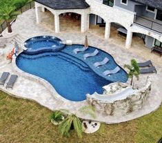 an aerial view of a backyard with a swimming pool