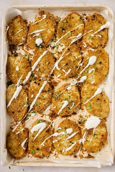 chicken patties covered in white sauce and parmesan cheese