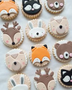 decorated cookies are arranged in the shape of foxes, deers and raccoons