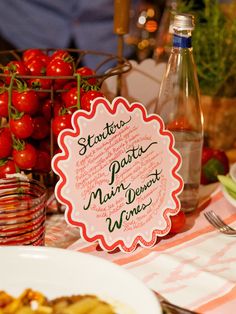 there is a plate of food and a bottle of wine next to it on the table