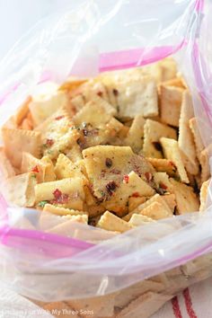 a plastic bag filled with crackers sitting on top of a table