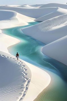 a man is walking through the sand dunes