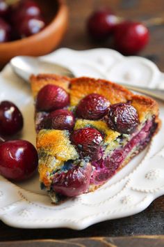 a piece of pie on a plate with cherries