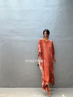 Legian Kaftan Take it easy this season in a simple & relaxed Kaftan that's just as effortless as it is chic. Made with lightweight and breathable rayon voile, loose & easy fit with an eye catching color blocking, this kaftan dress is perfect for every occasion - dressed up or down. * Color - Hand Tie dye - Brick   &  motif  * Size  One size fits all American size From S to XL *Total width  /220cm/86inch (round)  Chest & him /150cm/59inch(round)  The length /130cm/51inch * Stylepark1 Model  * Her height is 175Cm/5.74ft weight is 57kg/125Ib /American size, she wore  ~ M to large size.  Made from soft Rayon Voile Hand cool wash Material shrinkage will occur when dried in a tumble dryer. * At first, you may smell the unique hand print & dye . It will disappear after you wash it. So do not worr Casual Brown Kaftan For Spring, Casual Free Size Tunic Maxi Dress, Casual Orange Kurta For Summer, Casual Brown Free Size Dress, Brown Casual Free Size Dress, Long Sleeve Orange Kurta For Summer, Orange Long Sleeve Kurta For Summer, Summer Long Sleeve Orange Kurta, Casual V-neck Kurta For Summer