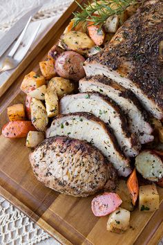 sliced pork, potatoes and carrots on a cutting board