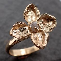 I have brought back my real flower collection!I created this ring from real flowers out of my garden. Each one is slightly different with a unique stone in the center. A rustic one-of-a-kind stone and setting as unique as you are. I create the setting in wax then cast it myself in my home studio. I carefully hand cut each prong to match the unique shape of the stones. The diamond is just under 3mm. The widest part of this ring is 17mm from petal end to petal end.The lilac flower has many meaning Rough Diamond Engagement Ring, Rough Gemstone Jewelry, Rough Diamond Ring, Flower Collection, Wedding Rings Solitaire, Wedding Engagement Ring, Floral Ring, Lilac Flowers, Enchanted Garden