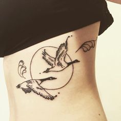 a woman with a tattoo on her stomach has a bird flying in front of the moon