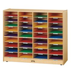 a large wooden storage unit filled with lots of different colored folders and labels on it