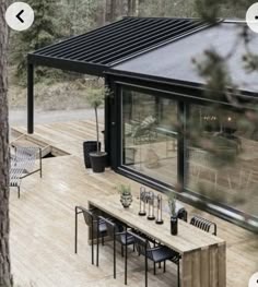 an outdoor dining area with chairs, table and patio furniture on the wooden decking