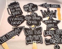 black and white photo of graduation party signs with wooden sticks in the shape of speech bubbles