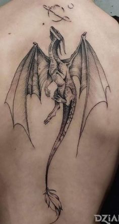 a dragon tattoo on the back of a man