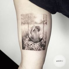 a black and white photo of a bird on a swing with grass in the background