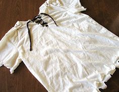 a white shirt laying on top of a wooden floor