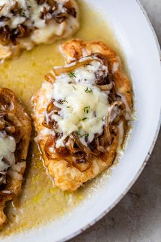 some food is on a white plate with gravy and meatballs in sauce