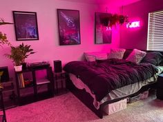 a bedroom with pink lighting and black furniture