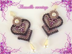 a pair of beaded earrings with pearls and beads in the shape of hearts on a white background