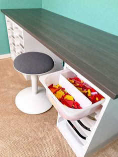 a kitchen counter with two trays filled with food on top of it next to a stool