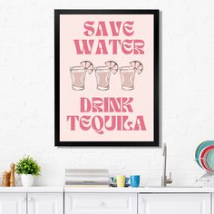 a pink poster that says save water drink tequila on the side of a white wall