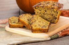 slices of banana bread on a cutting board with a pumpkin in the backgroud