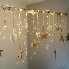 some lights are hanging from the ceiling in a room with stars and other decorations on it