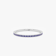 Kiki Celebrate September birthdays or your love for all things blue with this dainty Prong-Set Blue Sapphire Eternity Ring. This elegant piece features a continuous band of prong-set blue sapphires, symbolizing eternity and everlasting love. Delicately crafted and perfect for stacking, this ring adds a pop of color and sophistication to any outfit. - Handmade- Solid Gold- Natural Sapphire- Total Sapphire Carat Weight: 0.29 ctw- Band Thickness: 1.3 mm All pieces come beautifully boxed in suede po Blue Sapphire Eternity Band, Sapphire Eternity Band, Sapphire Eternity Ring, Dainty Gold Rings, Handmade Fine Jewelry, Handmade Beauty Products, September Birthstone, Natural Blue Sapphire, Eternity Band