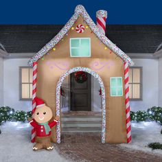 an inflatable gingerbread house is decorated with candy canes