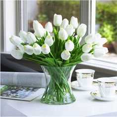 PRICES MAY VARY. 【Flower Type】40 Heads Large White Tulip Floral Arrangement in Clear Glass Vase 【Product Size】Overall dimension of real touch artificial flower bouquets with vase is approx 14H x 14W inches, Clear unique glass vase is approx 7H x 6W inches. 【Unique Designs】Each tulip bouquet arrangement is handcrafted. The faux flower is made of high-grade PU and real touch, the fake flower stem is wrapped in plastic wire, the clear cylinder glass vase is crafted with thick glass and a stable bot Tulpen Arrangements, Table Transparente, Growing Tulips, Tulips Arrangement, Clear Glass Vase, Tulips In Vase, Tulip Bouquet, Artificial Flower Bouquet, Home Wedding Decorations