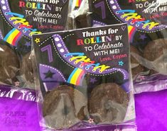 chocolate covered cookies in plastic bags on purple table cloth with name tag and rainbow theme