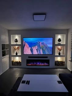 a living room with a flat screen tv on the wall and built - in fireplace