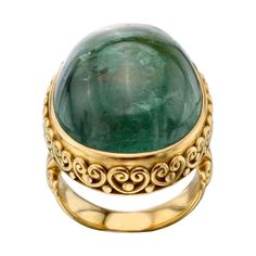 A large beautiful blue-green tourmaline oval cabochon accompanied with hand soldered delicate spiral bezel accents will be an object of admiration for the owner of this ring. Currently size 7, but can be resized. The stone is approximately 18x22mm. Total weight 19 grams. Bridal Jewels, 18k Gold Ring, Green Tourmaline, Oval Cabochon, Ring Ring, Cocktail Ring, Cocktail Rings, Beautiful Blue, Beautiful Rings