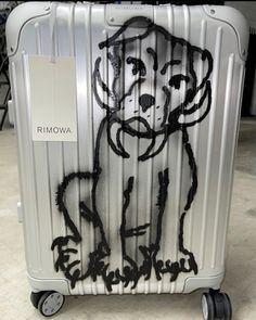 a piece of luggage with a drawing of a dog on it's side and wheels