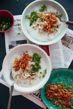 two bowls filled with food sitting next to each other on top of a newspaper page