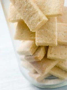 a glass filled with sugar cubes sitting on top of a table