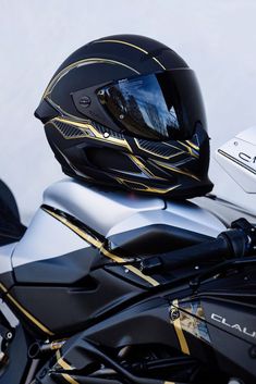 a helmet is sitting on the back of a motorcycle