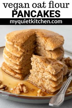 a stack of vegan oat flour pancakes on a plate with a bite taken out