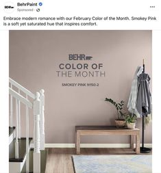 an ad for the behr color of the month smoky pink is displayed on a wall