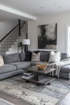 a living room filled with furniture and a stair case