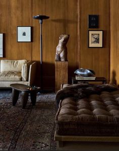 a living room filled with furniture and pictures on the wall