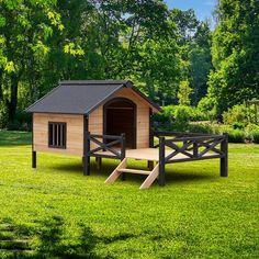 a dog house with a wooden bench in the grass