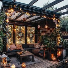 an outdoor living room is decorated with lights