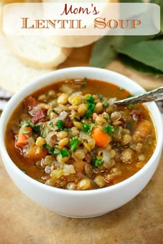 a white bowl filled with soup next to slices of bread