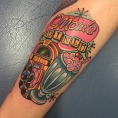 a colorful tattoo on the arm that says mom's dinner with an image of a jukebox