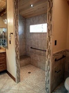 a bathroom with a walk in shower next to a sink